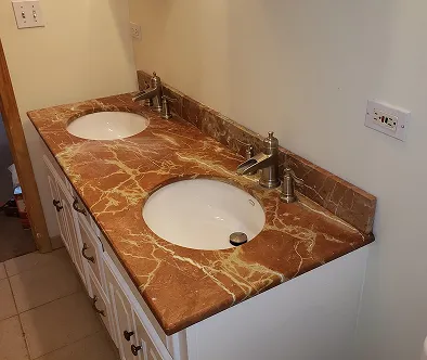 Bathroom vanity with double sinks and marble countertop