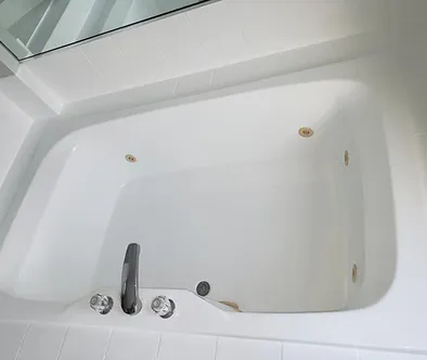 White jacuzzi bathtub with chrome faucet and jets