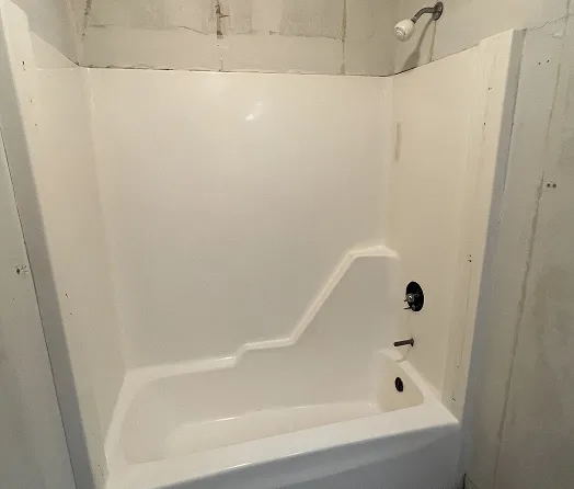 White bathtub with purple walls