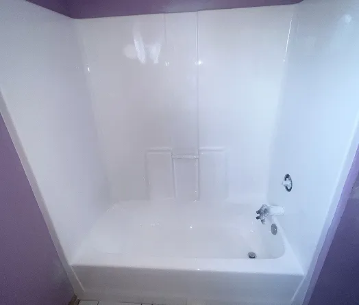 White bathtub with purple walls