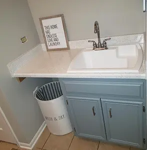 Laundry room sink with framed This home has endless love and laundry sign and laundry hamper.