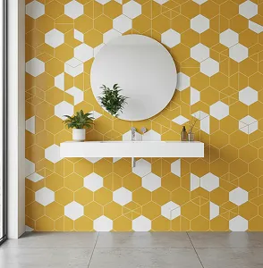 Yellow hexagonal tile wall with white accents and a round mirror above a floating sink